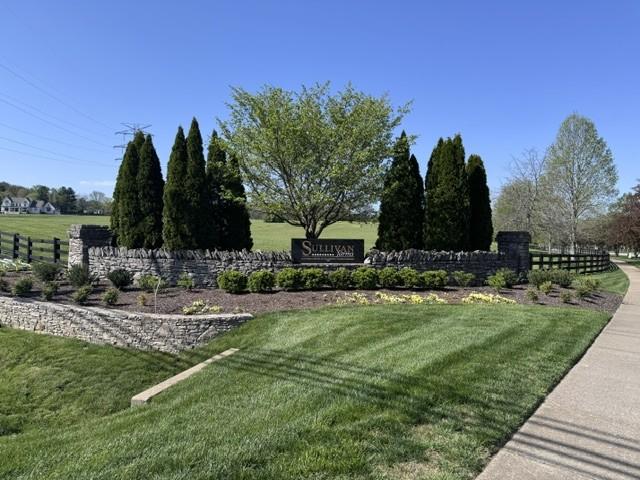 view of community with a yard and fence