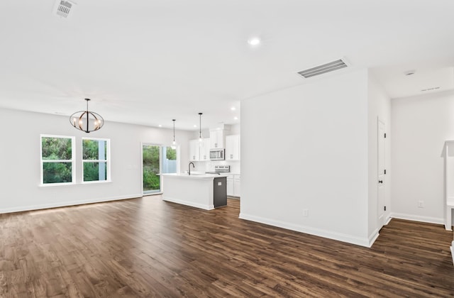 unfurnished living room featuring dark wood-style floors, visible vents, and recessed lighting