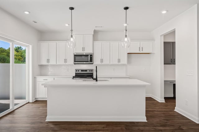 kitchen with a sink, white cabinets, and stainless steel appliances