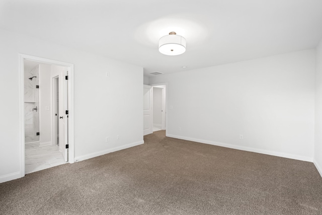 spare room with baseboards and carpet