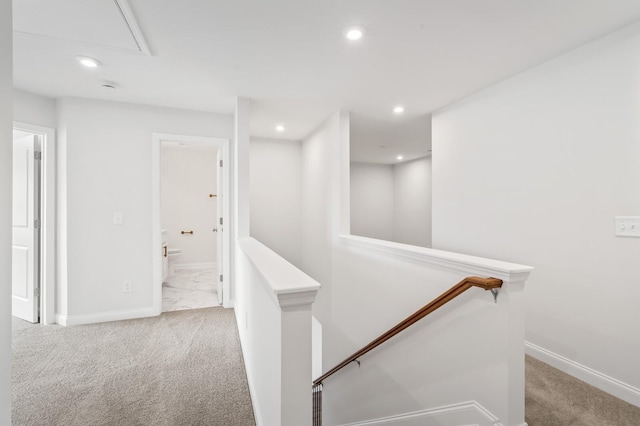 corridor with an upstairs landing, recessed lighting, and carpet floors