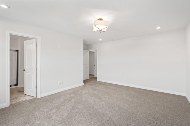 spare room with carpet flooring, recessed lighting, and baseboards