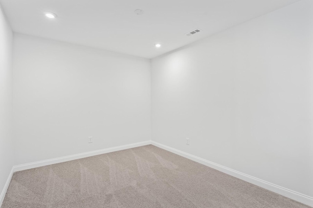 empty room with recessed lighting, visible vents, baseboards, and carpet