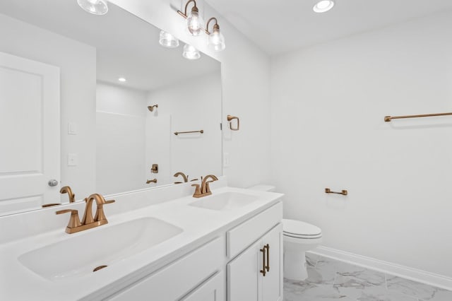 full bath featuring marble finish floor, toilet, baseboards, and a sink