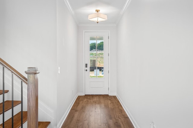 doorway with stairs, baseboards, wood finished floors, and crown molding