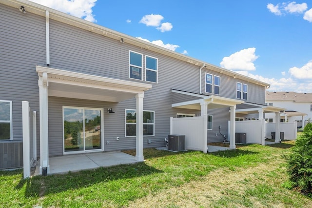 rear view of property featuring a patio, a yard, fence, and cooling unit