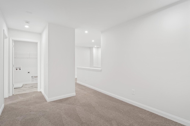 carpeted spare room featuring recessed lighting and baseboards