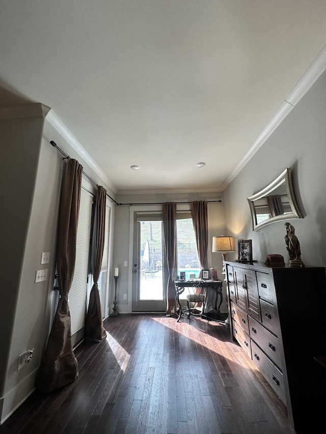 bedroom featuring dark wood-style floors, crown molding, baseboards, and access to outside