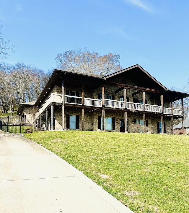 view of front of property with a deck and a front yard