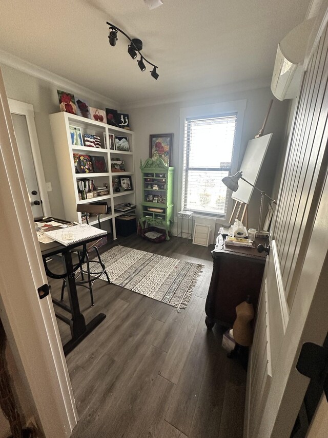 home office featuring a wall mounted AC, crown molding, and wood finished floors