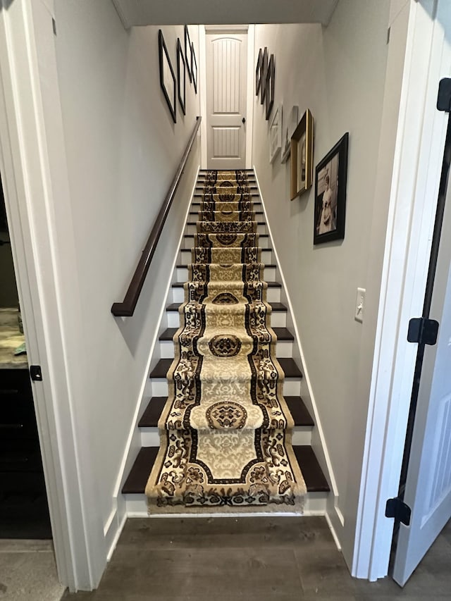 stairs featuring baseboards and wood finished floors