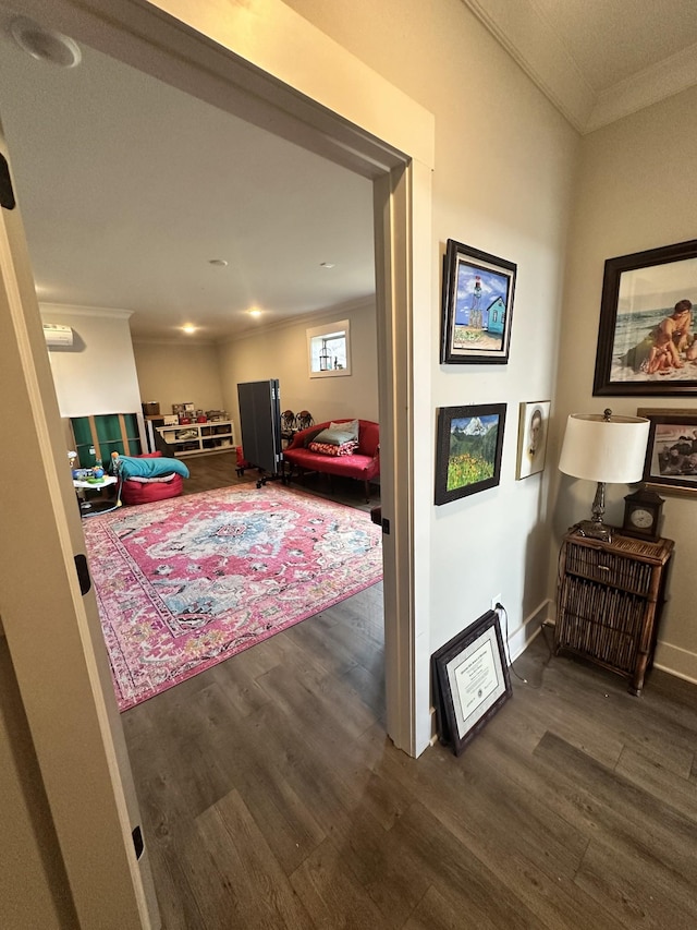 hall with crown molding, baseboards, and wood finished floors