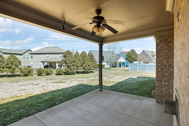 view of patio / terrace with a fenced backyard, a residential view, and ceiling fan