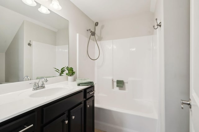 bathroom featuring shower / washtub combination and vanity