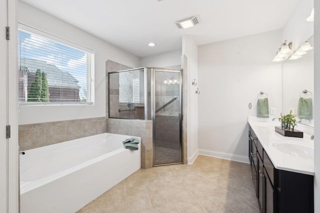 bathroom with visible vents, double vanity, a sink, tile patterned flooring, and a garden tub