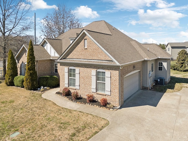 traditional-style home featuring brick siding, central air condition unit, a front yard, roof with shingles, and an attached garage