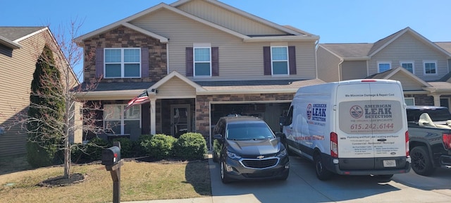 view of front facade with a garage, stone siding, and driveway