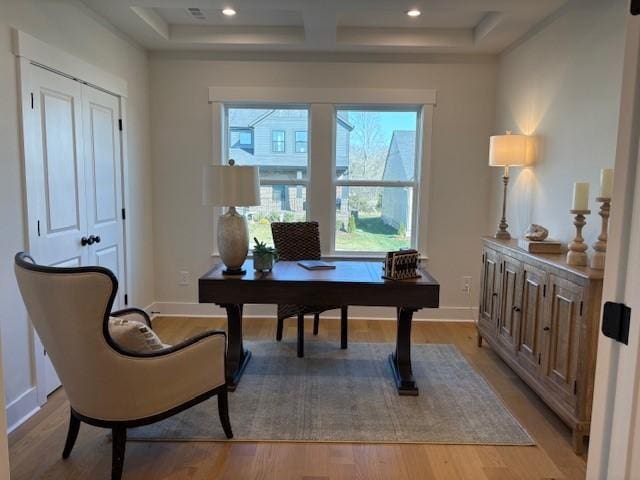 office area with baseboards, coffered ceiling, recessed lighting, light wood-style floors, and beamed ceiling