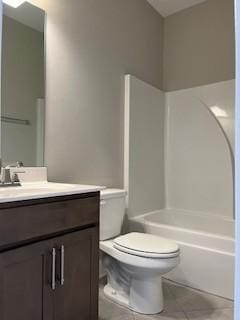 full bathroom featuring tile patterned floors, bathing tub / shower combination, toilet, and vanity