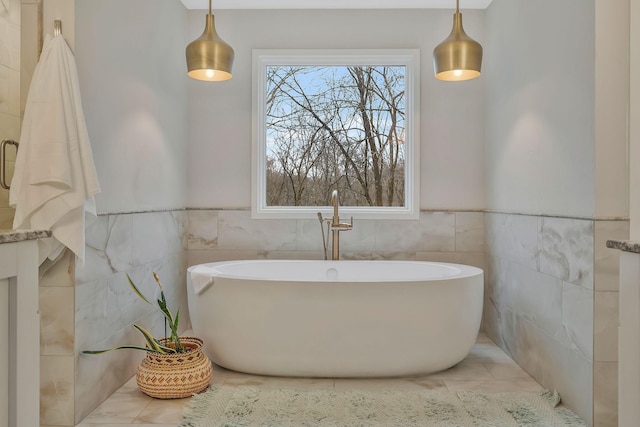 full bath featuring tile walls and a freestanding tub