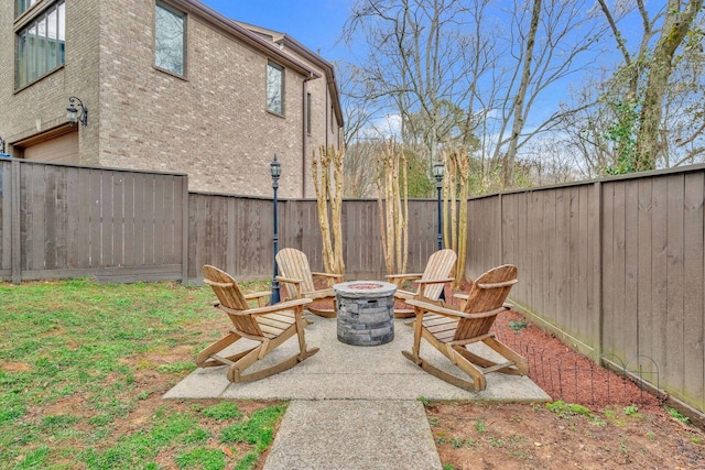 view of yard with a patio area, an outdoor fire pit, and a fenced backyard