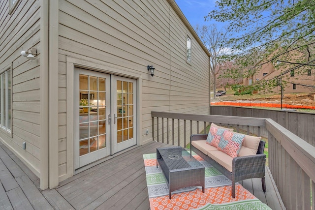 wooden terrace featuring french doors and an outdoor hangout area