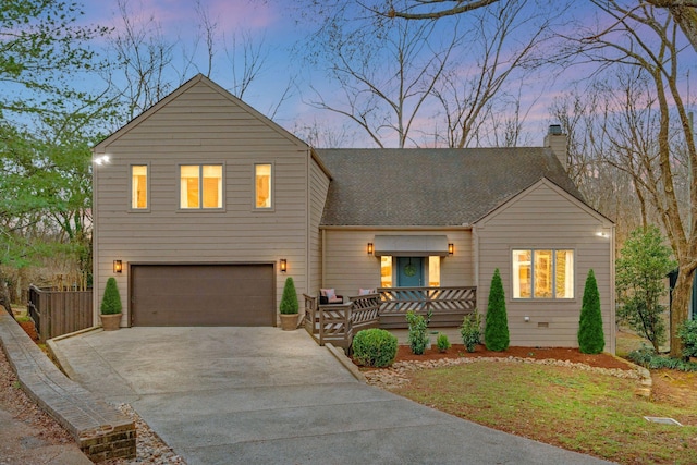 view of front of property with roof with shingles, an attached garage, driveway, and a chimney