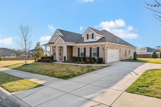 view of front of house with driveway, brick siding, a front yard, and fence