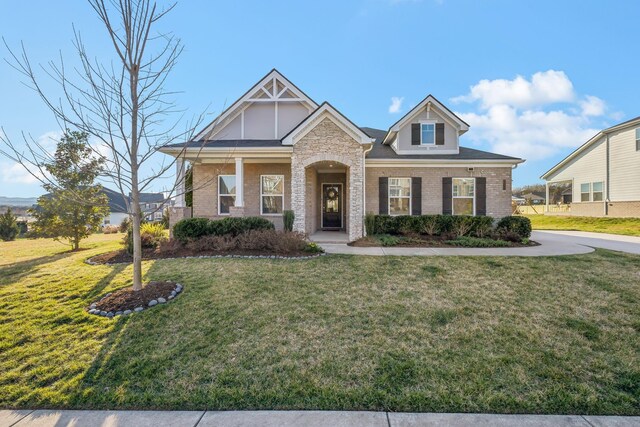 craftsman-style house with brick siding and a front yard