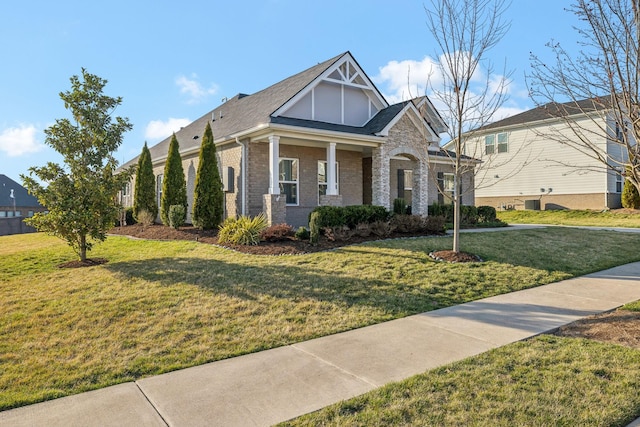 view of front of house featuring brick siding and a front yard