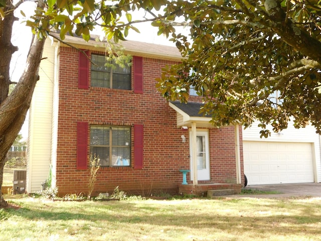 view of front of home featuring brick siding, driveway, a front lawn, and a garage