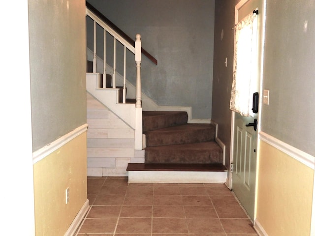 staircase with tile patterned floors