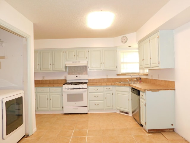 kitchen featuring under cabinet range hood, a sink, washer / dryer, dishwasher, and white gas range