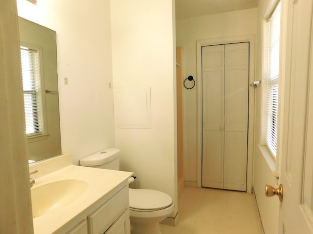 bathroom with tile patterned floors, toilet, and vanity