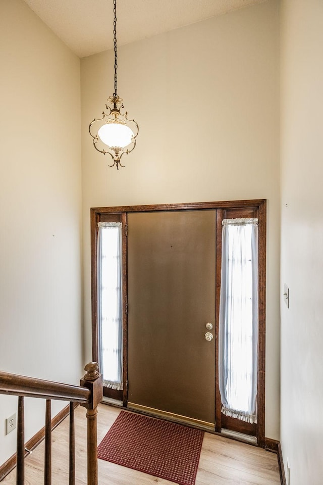 foyer with light wood finished floors and baseboards