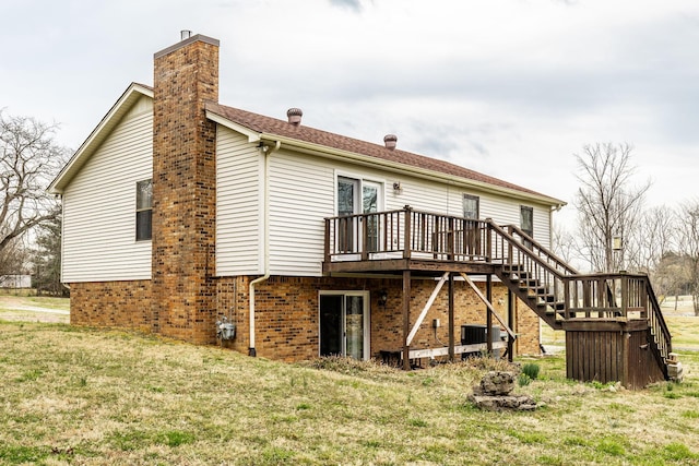 back of property with central AC unit, a wooden deck, a chimney, stairs, and a lawn