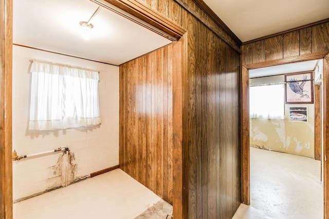 interior space with wooden walls and concrete block wall