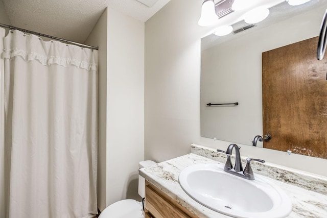 bathroom with visible vents, toilet, curtained shower, a textured ceiling, and vanity