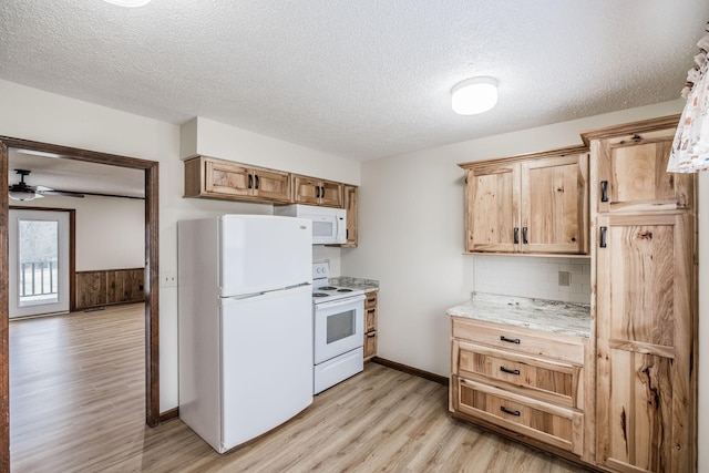 kitchen featuring white appliances, light wood-style floors, tasteful backsplash, and a textured ceiling