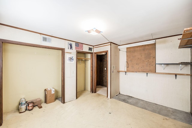 unfurnished bedroom with visible vents and concrete floors