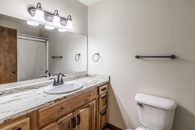 full bathroom featuring vanity and toilet