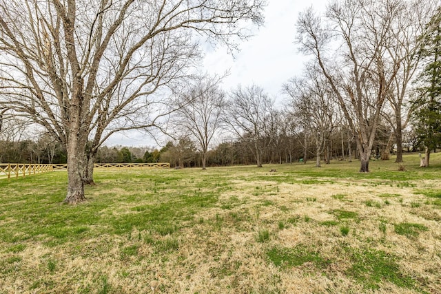 view of yard featuring a rural view and fence