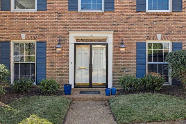 doorway to property with brick siding