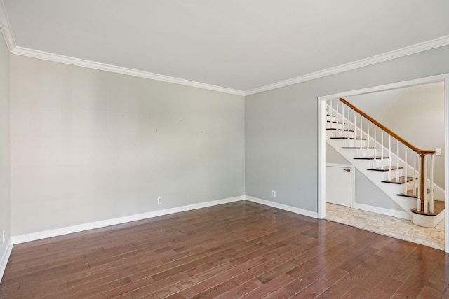 unfurnished room with stairs, wood finished floors, baseboards, and ornamental molding