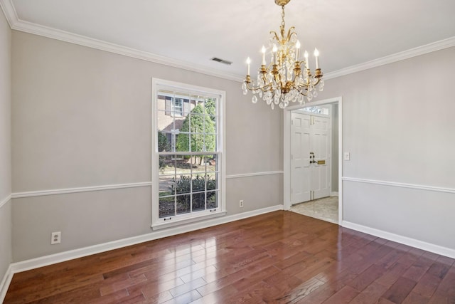 interior space with visible vents, baseboards, wood finished floors, and crown molding