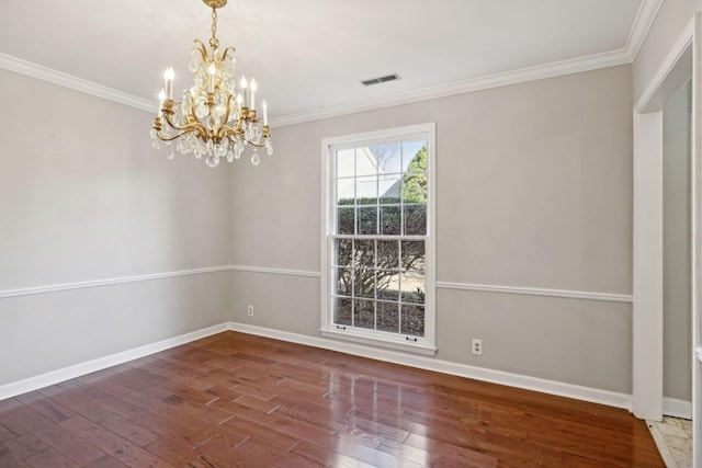 unfurnished room featuring visible vents, crown molding, baseboards, and wood finished floors