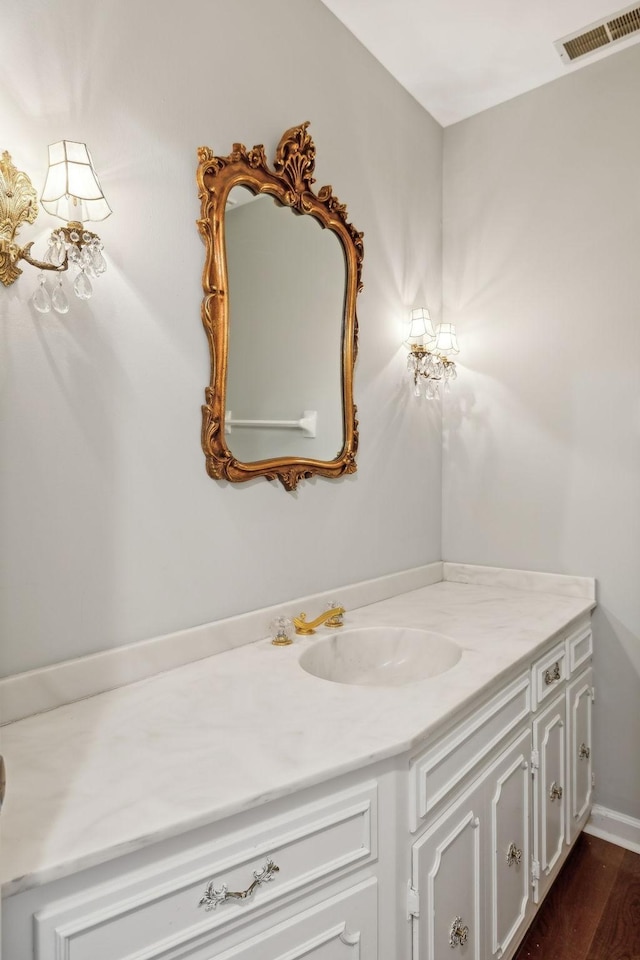 bathroom with visible vents, wood finished floors, and vanity