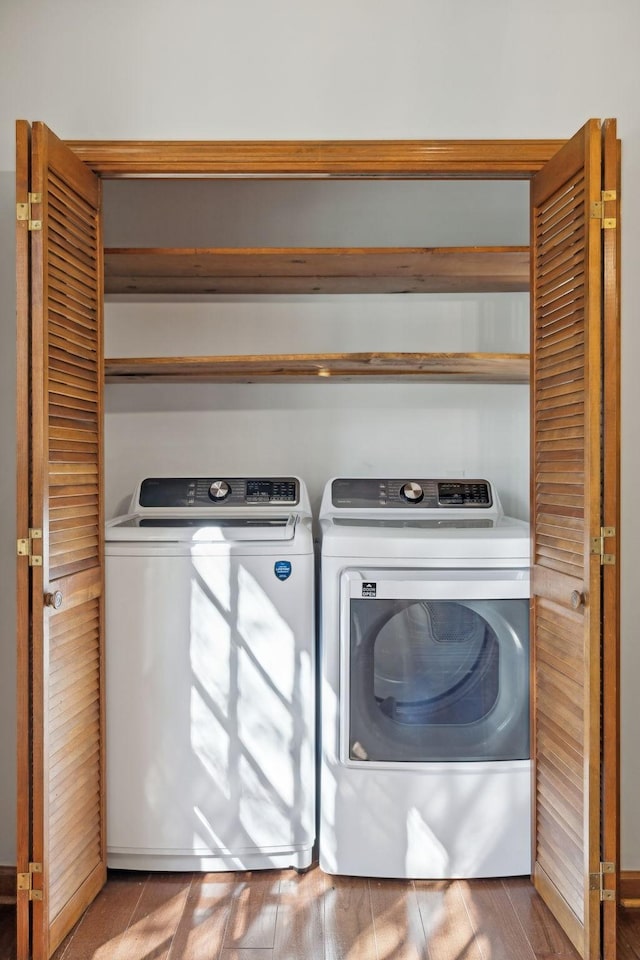 washroom with laundry area, independent washer and dryer, and wood finished floors