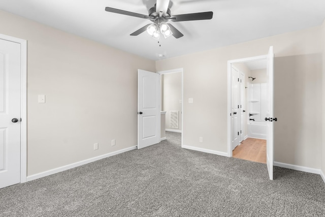 unfurnished bedroom featuring baseboards, carpet floors, and visible vents