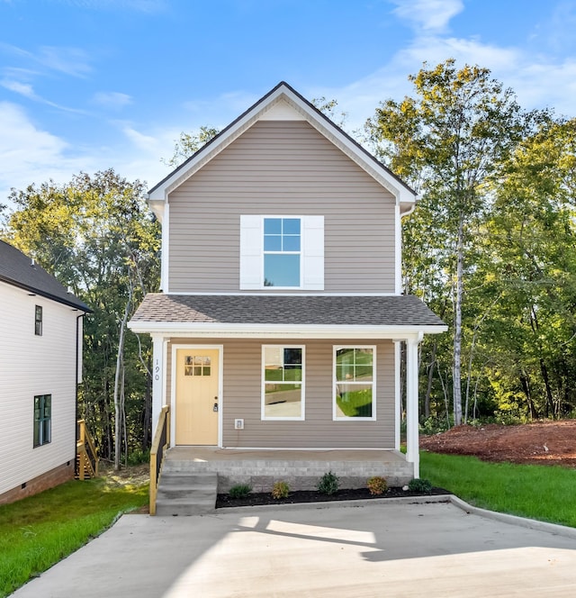 view of front of house featuring covered porch, a front lawn, and a shingled roof